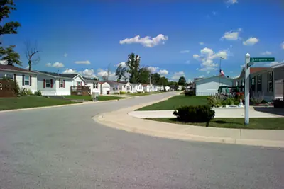A quiet street of manufactured homes in a planned community