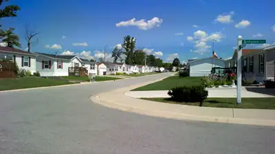 A quiet street of manufactured homes in a planned community